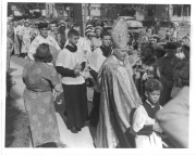 Archbishop Hoban proceeding from St. Barbara's rectory to the church.  In the background is a view of East Denison Hardware.